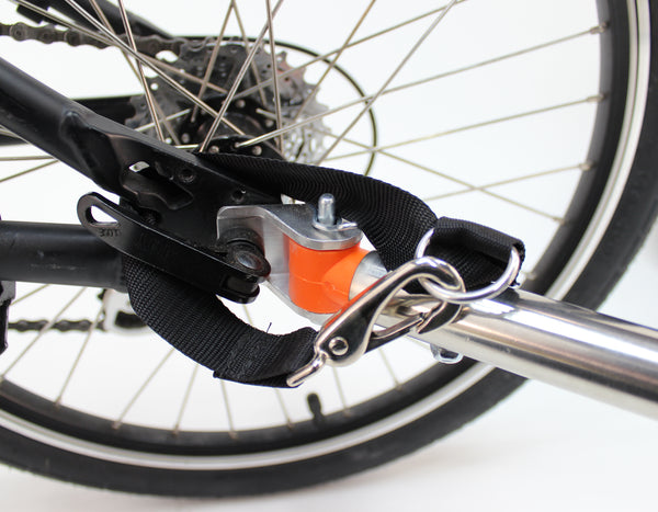 Example of safety strap installation onto bicycle frame; loop around frame and re-attach to towbar.