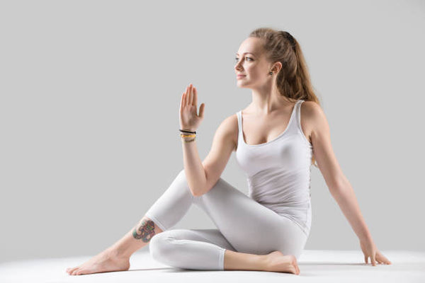 women doing Ardha Matsyendrasana or Seated Twist-Travel Yoga Poses-Mikkoa Yoga