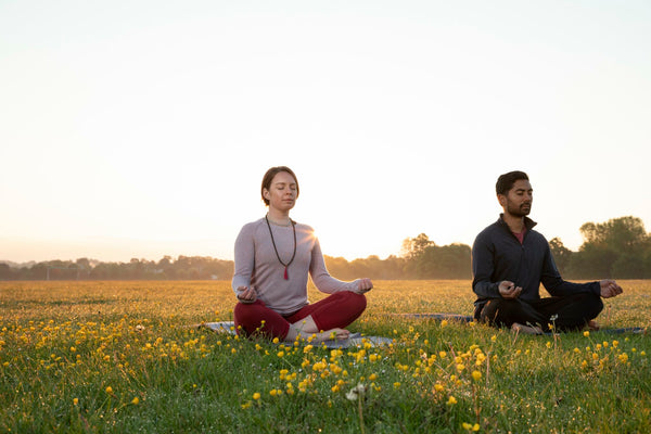 women and men doing yoga in flower garden-Rishikesh yoga capital-mikkoa yoga