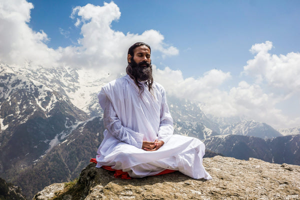 man doing yoga on Himalayan mountain-Transcendental Meditation-mikkoa yoga