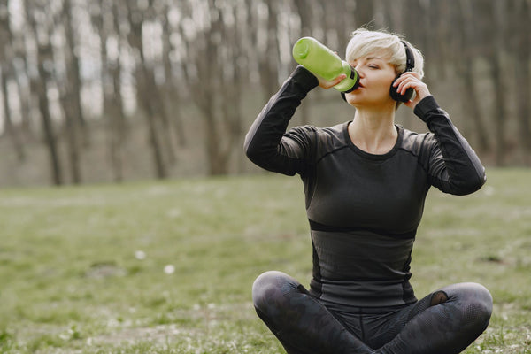 women drinking water while doing exercise-yoga mat-mikkoa yoga
