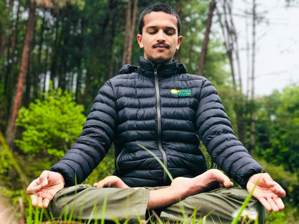 man doing yoga on grass ground-yoga mat-mikkoa yoga