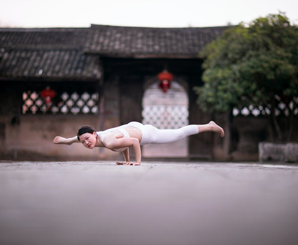 girl balancing body on hand-vietnam yoga retreat-mikkoa yoga