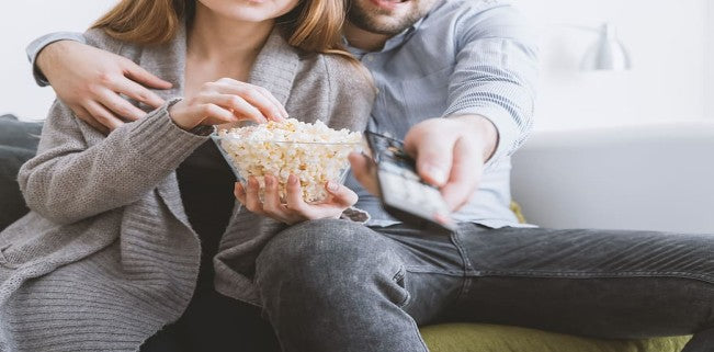 couple on couch eating popcorn