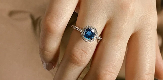 london blue topaz ring on hand