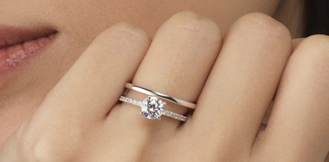 engagement ring and wedding band on hand