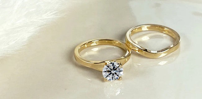 yellow gold wedding set on surface