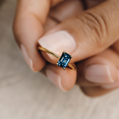 Gold Vermeil London Blue Topaz Baguette Ring - Charlotte standing up on patterned background