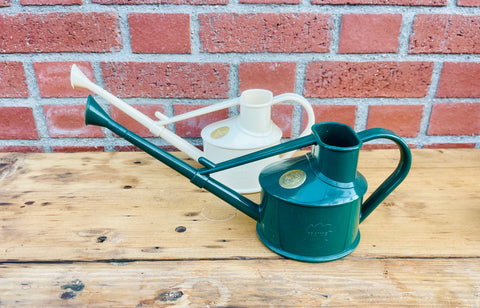 Haws small watering cans in forest green and cream colors.