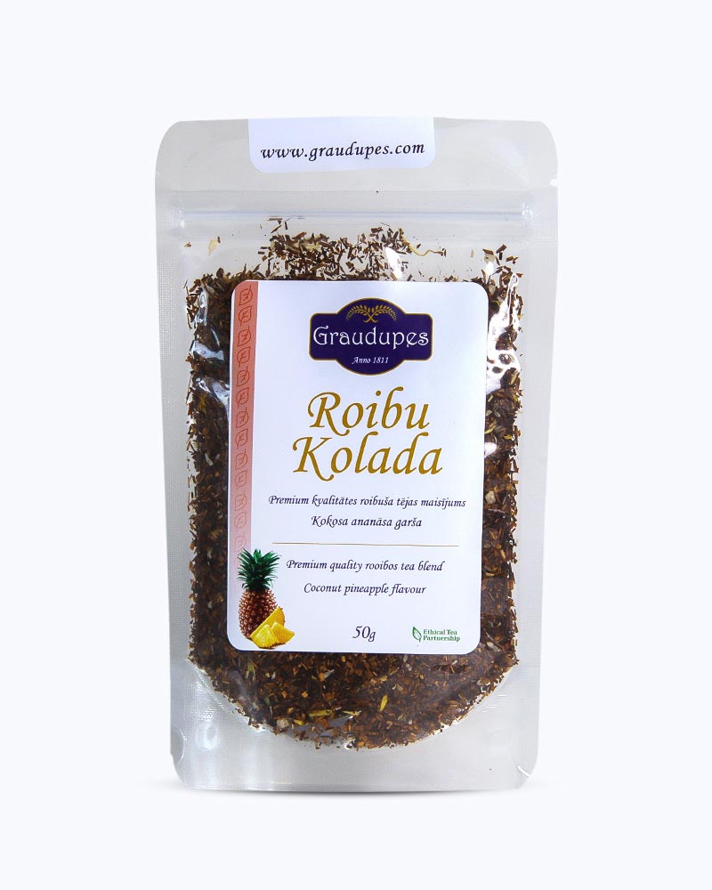 Thé emballé dans un doypack transparent, face recto. Rooibo Colada, Graudupes Rooibos et Honeybush Tea Blend, Piña Colada Rooibos Mix, Thé en feuilles avec morceaux de noix de coco et ananas séchés.