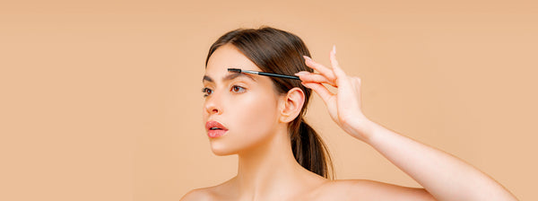 Woman using eyebrow pencil