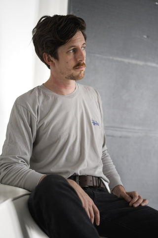 A man sitting in a leather belt