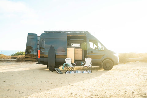 sandy van set up at a camping spot