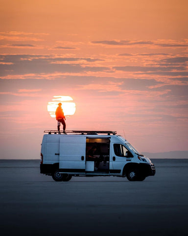 danny mcgee van adventure creator with his van in bolivia salt flats sunrise