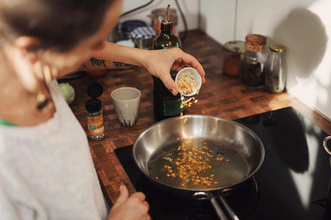 woman cooking stir fry on electric stove