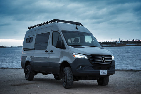 sprinter van parked in front of water