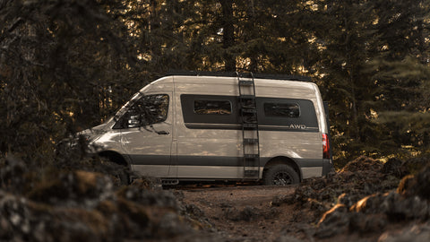 sprinter van parked in the woods