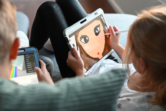 A girl and a boy are enjoying screen time by playing a color by number app together.