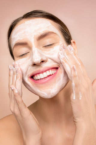 woman applying natural ingredients to her radiant skin