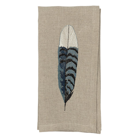 Blue jay feather on cloth napkin