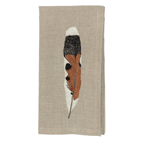 A feather on a cloth napkin