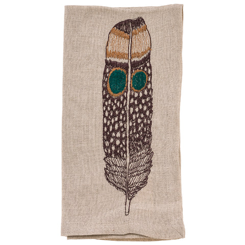 Owl feather on a cloth napkin