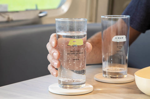 Two glasses sitting on a table in an Airstream