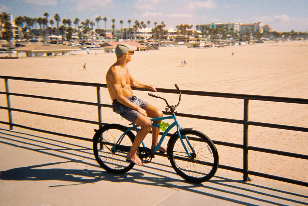 Man on bike near the sunny beach of California