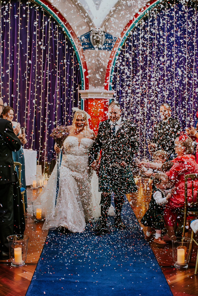 Bride and groom just married with confetti being thrown