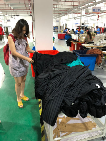 Inspecting the sewing line of my dresses in Shanghai
