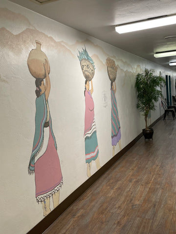 A mural on the interior wall of women carrying baskets on their heads at Boulevard Circle in Walnut Creek CA.