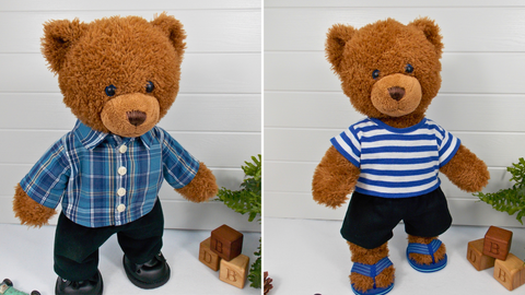 Two Build a Bear teddy bears. The teddy bear on the left is wearing a blue checked shirt, black pants, & black shoes. The teddy bear on the right is wearing a blue & white striped t-shirt, black shorts & blue sandals. Both teddy bears are standing in front of a white background with a green fern plant & wooden bricks on the right hand side.