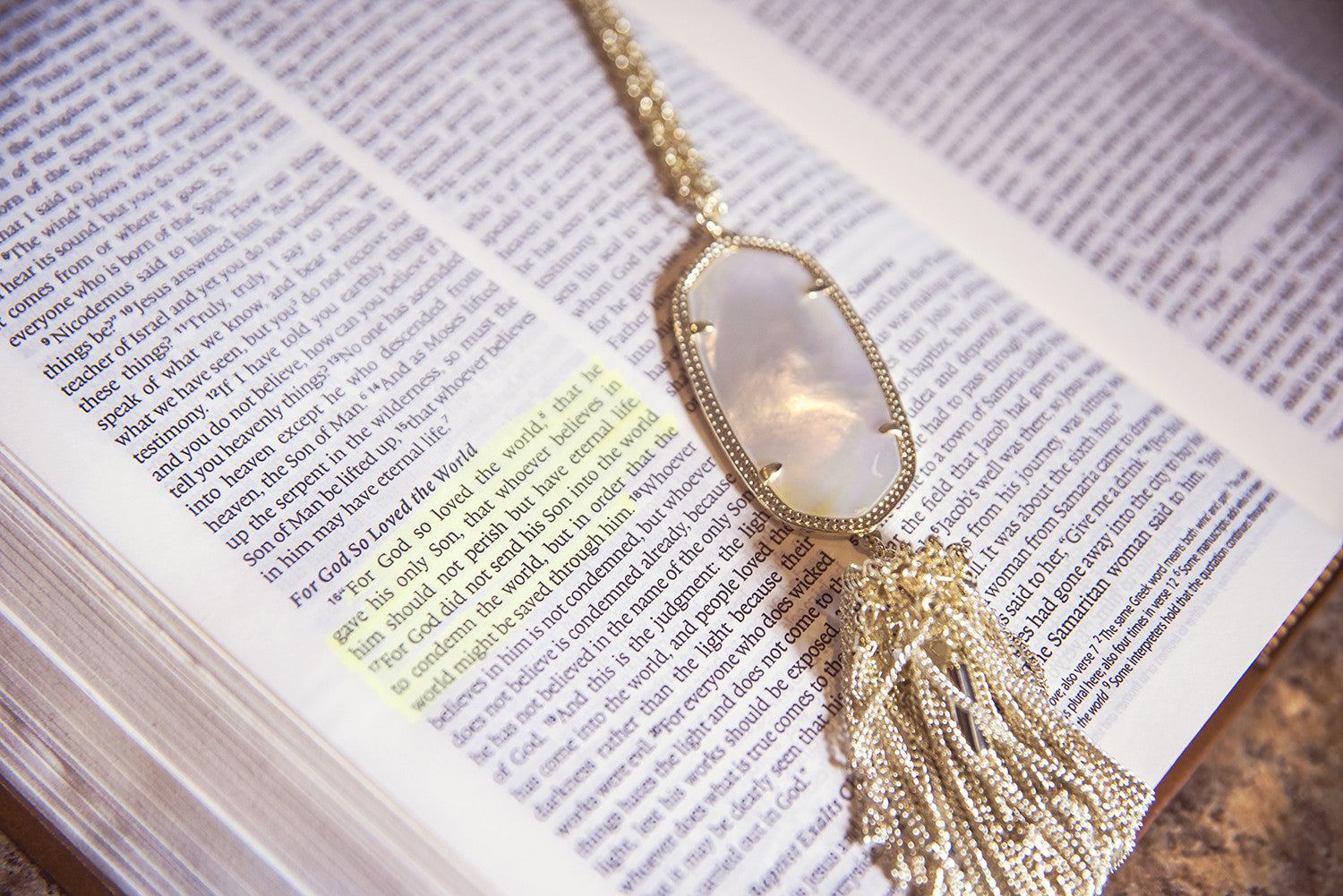 Kendra Scott Jewelry at Eccentrics Boutique. Kendra Scott necklace on Bible next to highlighted John 3:16.