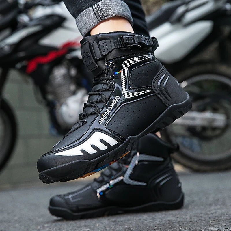 “Person in black and white Racing Boots, designed for motorsport, foot on a motorcycle peg.”