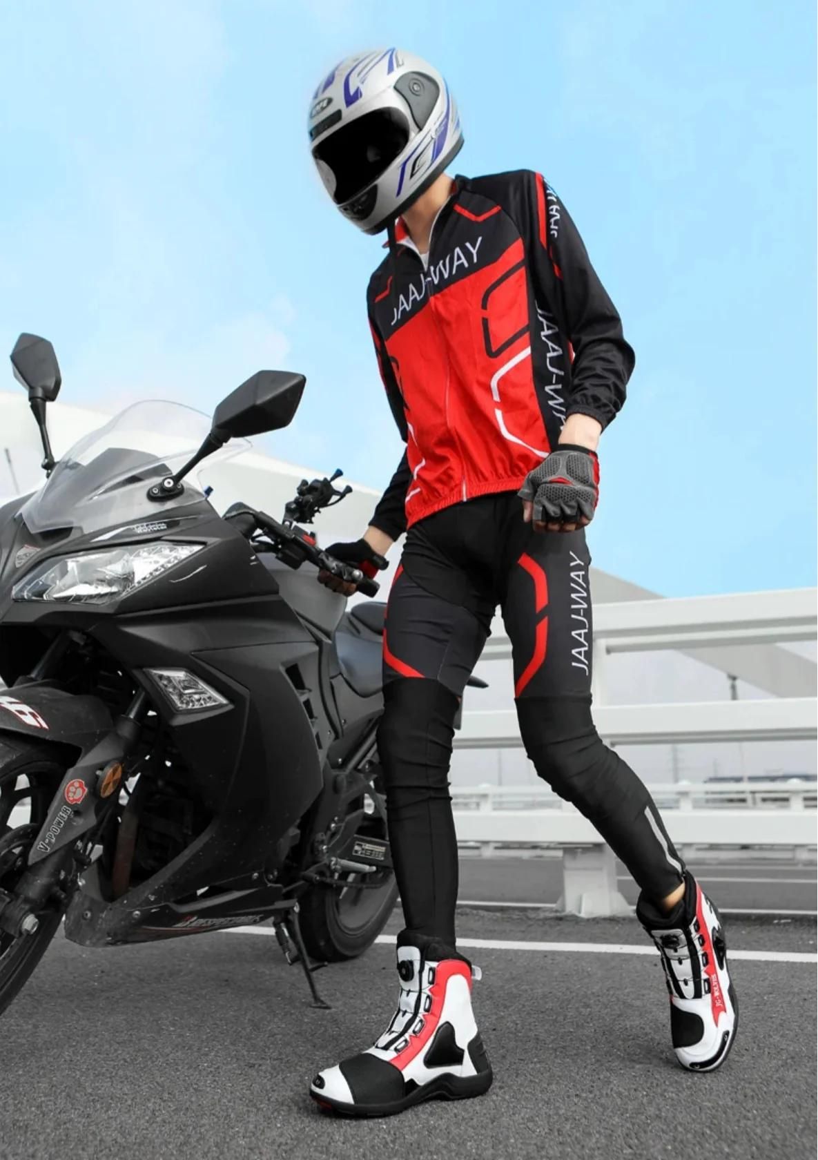 Waterproof in professional gear beside a sleek motorcycle, under clear skies, ready for a ride