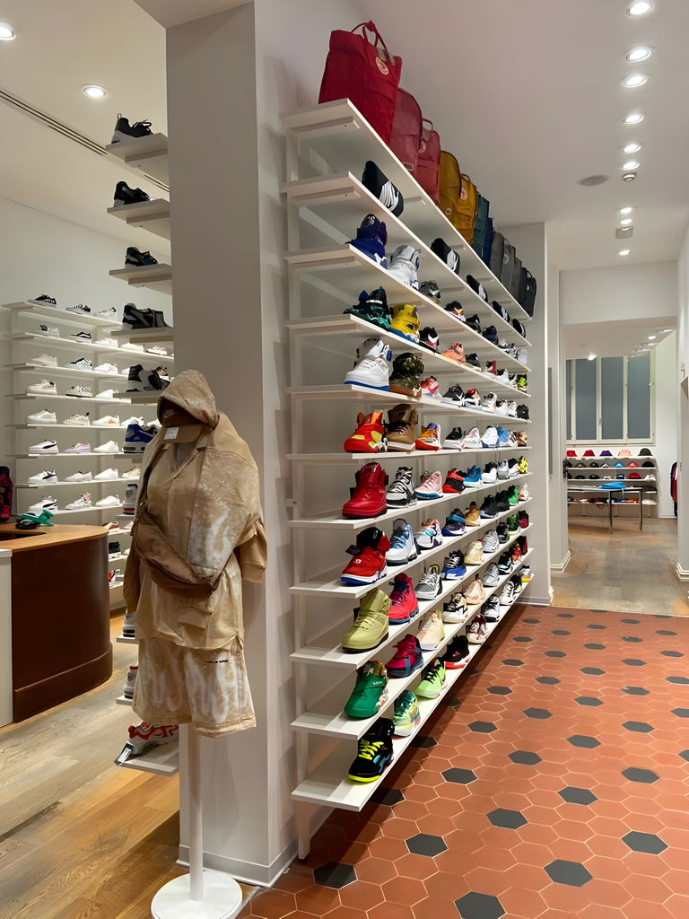 Sneakers wall with sneakers from the best streetwear brands and total look mannequin Vision of Super, Italian street luxury brand, inside the Atipici Shop Bologna store in via Clavature 14