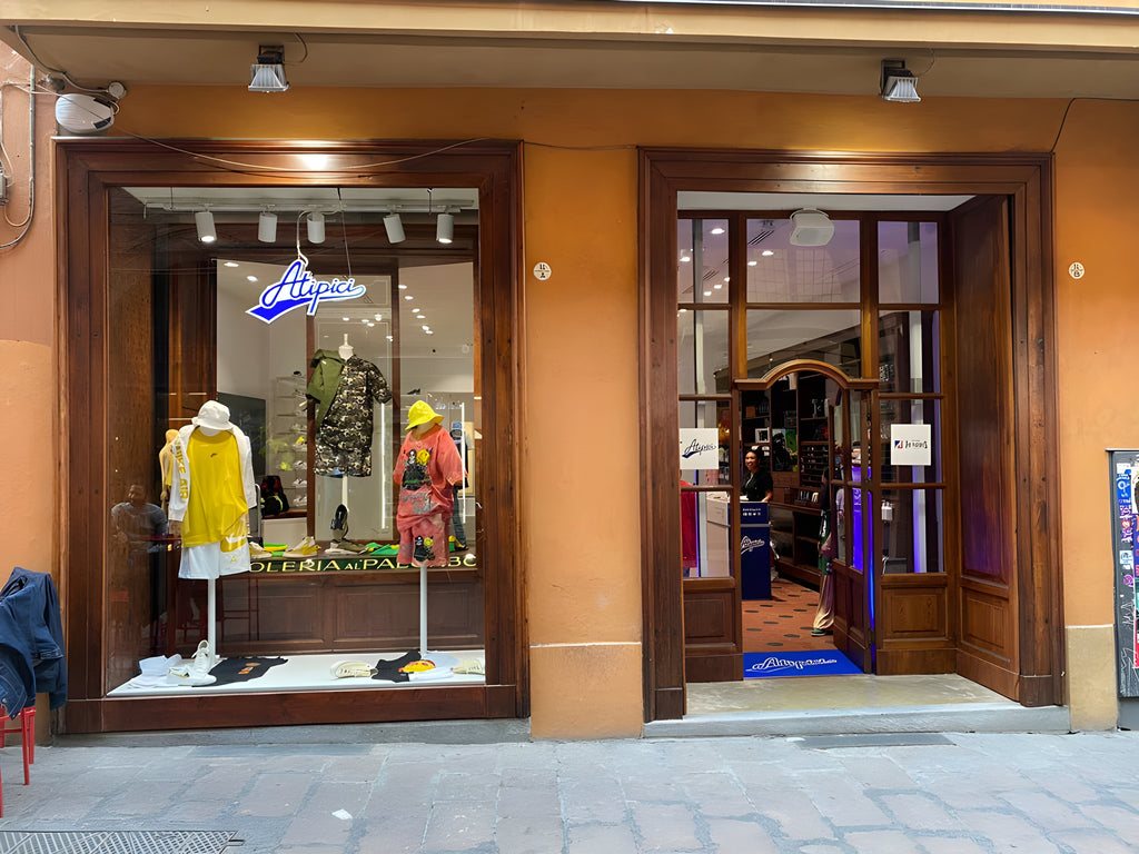 Exterior of the windows of the Atipici Shop Bologna streetwear clothing store in via Clavature 14