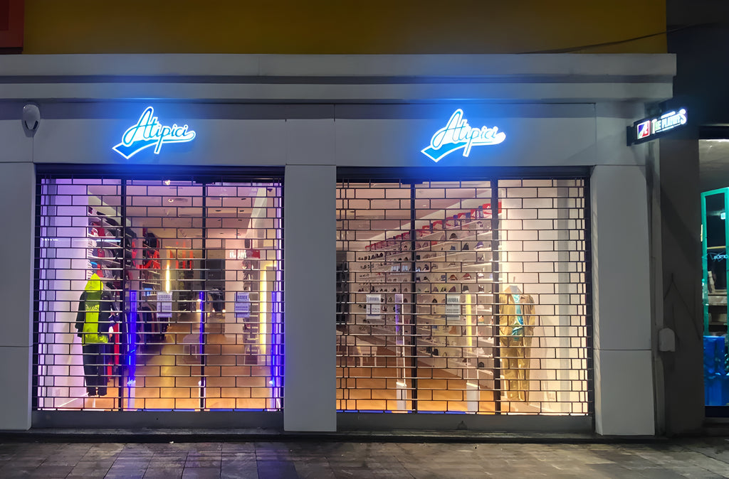 Exterior of the Atipici Shop Milano streetwear store in Corso Buenos Aires 25, windows with illuminated signs