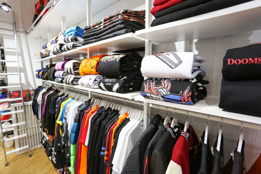 Selection of hooded sweatshirts, crewneck sweatshirts and streetwear and sportswear t-shirts displayed inside the Atipici Shop Novara store