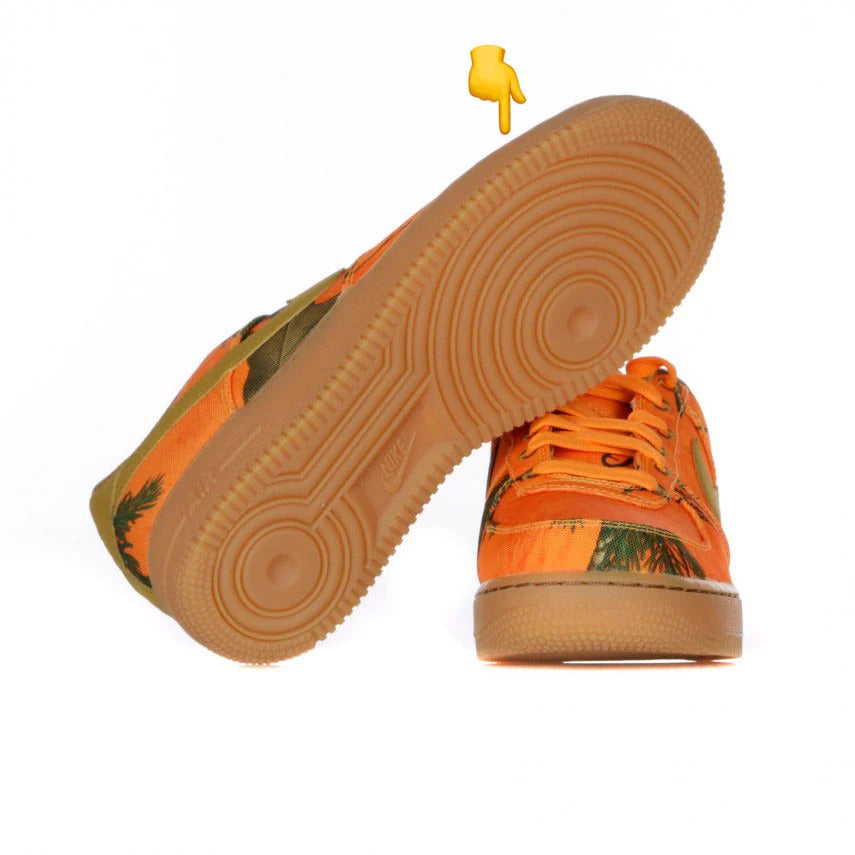 Pair of Nike Air Force 1 sneakers in a particular colorway with Gummy Sole, the iconic brown rubber sole