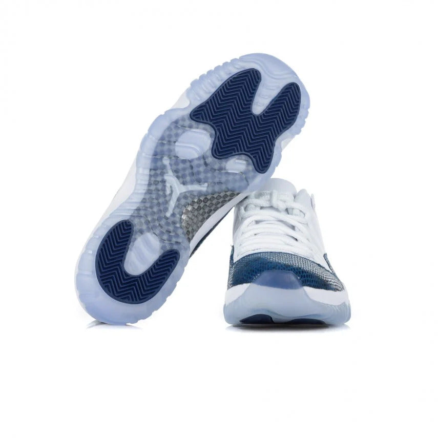 Pair of Air Jordan 11 Retro Low colorway White/Black/Navy basketball sneakers with outer sole in Icy material and color in transparent light blue