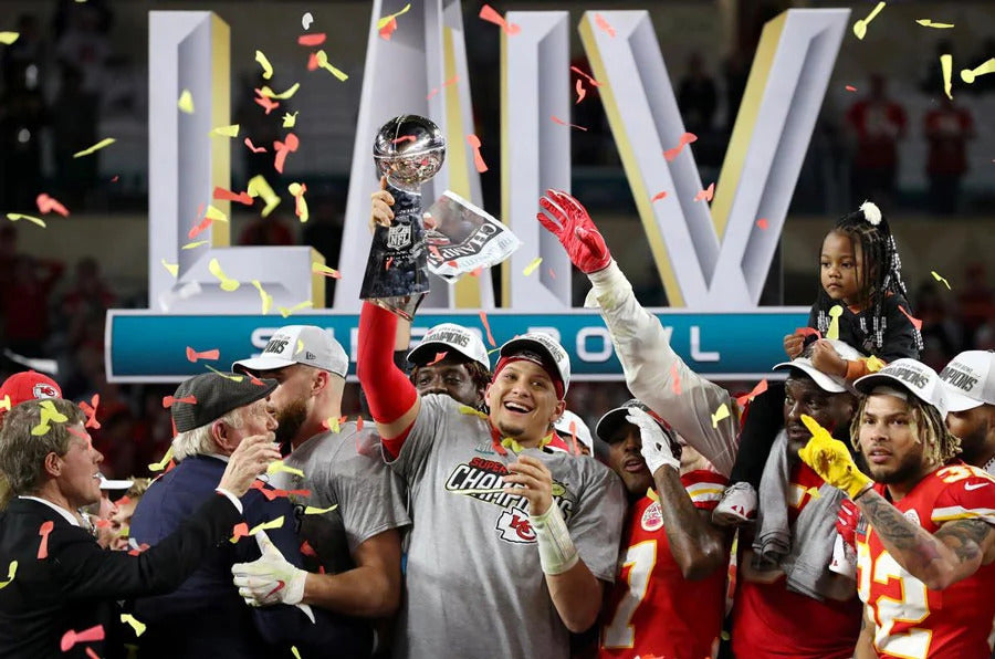 Kansas City Chiefs team celebrate winning Super Bowl LIV with Patrick Mahomes holding up the trophy