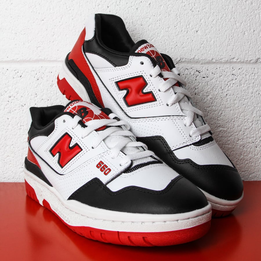 Pair of low basketball sneakers, New Balance 550 Team Red padded skate shoes