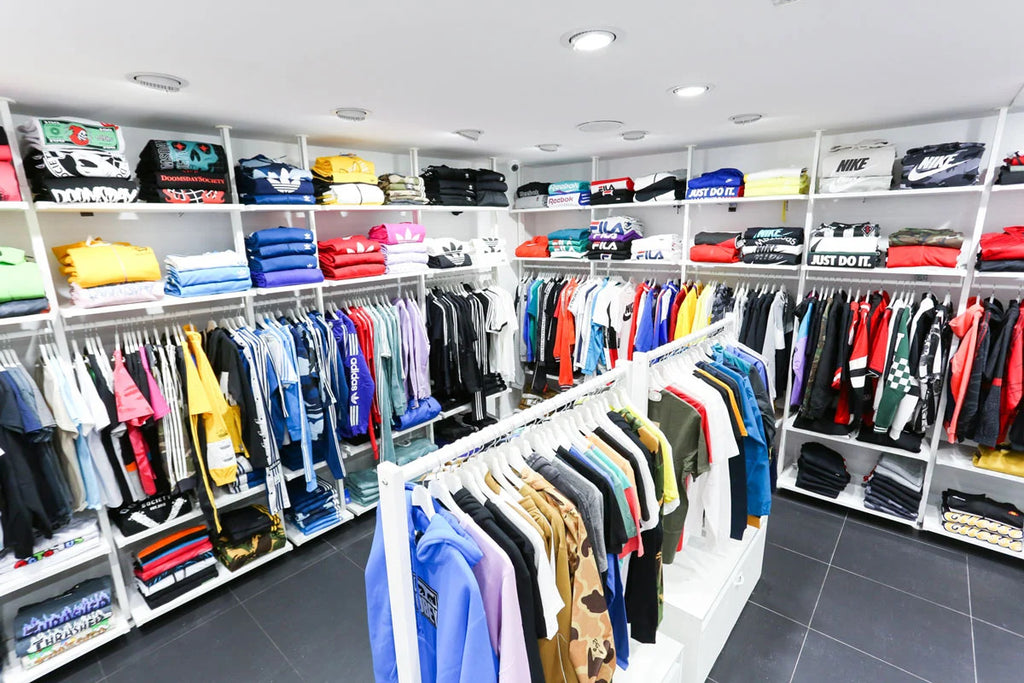 Selection of streetwear and sportswear clothing displayed inside the Atipici Shop Cuneo store in Corso Nizza, 4