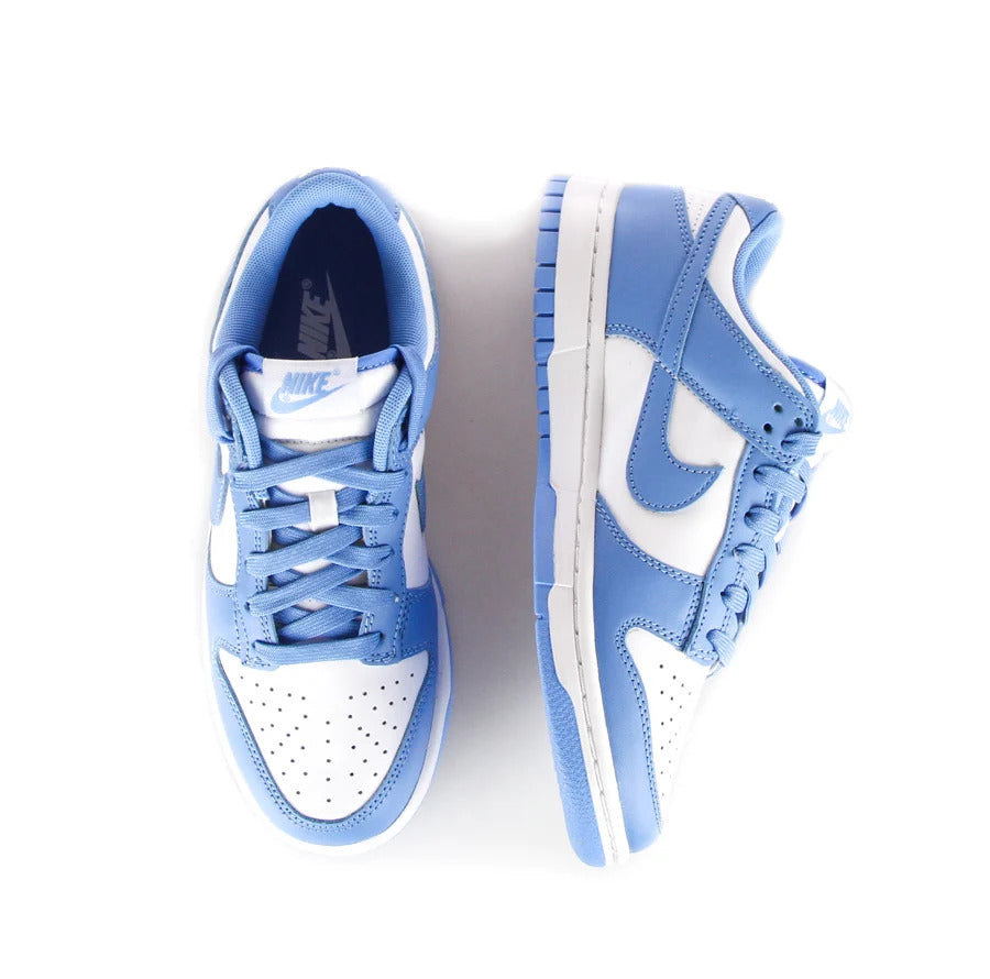 Pair of Nike Dunk Low UNC low sneakers in the white/light blue "University Blue" colorway in honor of the colors of the University of North Carolina