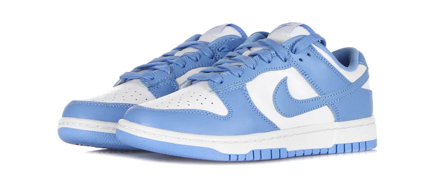Pair of Nike Dunk Low UNC low sneakers in the white/light blue "University Blue" colorway in honor of the colors of the University of North Carolina