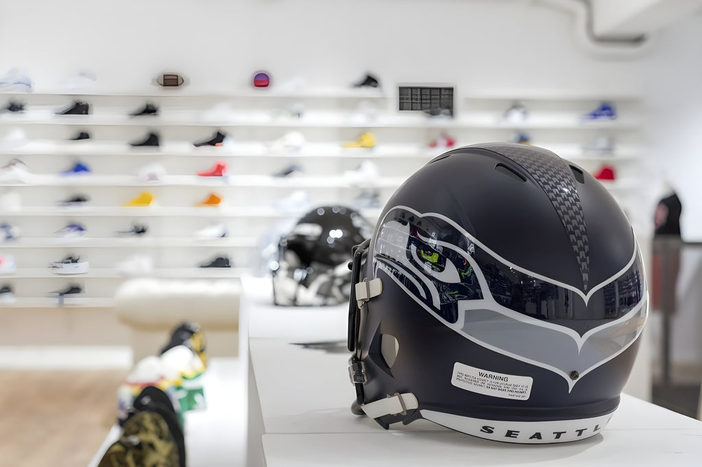 Original NFL American foodball helmet with Seattle Seahawks graphics on display inside The Playoffs Torino store in Via Roma 220