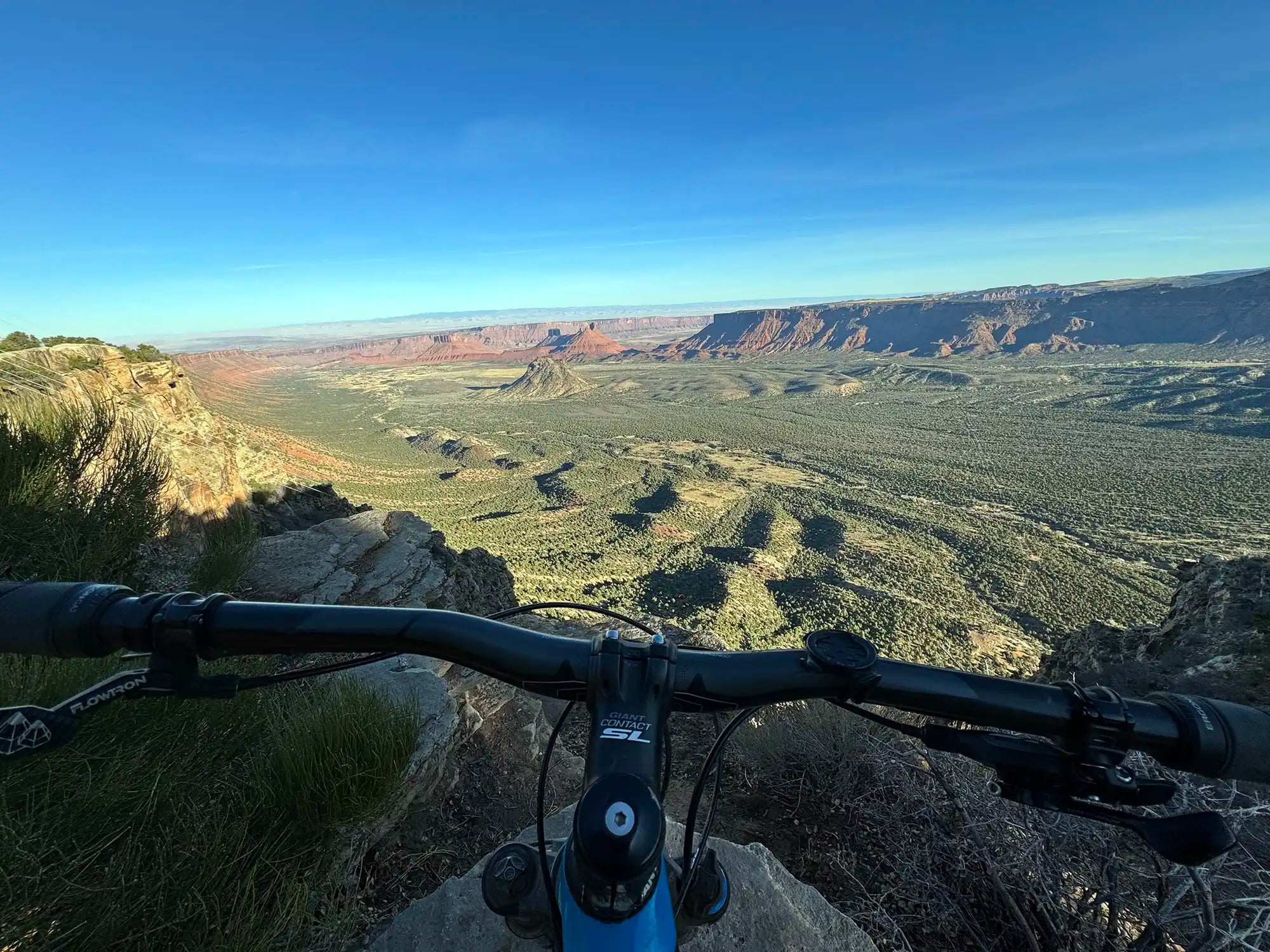 Handle bars of a mountain biking looking over the whole enchilada trail