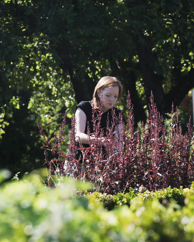 international Women's Day, Charmaine, owner of Chapters Restaurant tending her garden