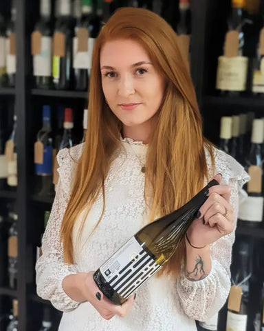 International Women's Day, Emma Giles, In the Secret Bottle Shop holding a bottle of wine
